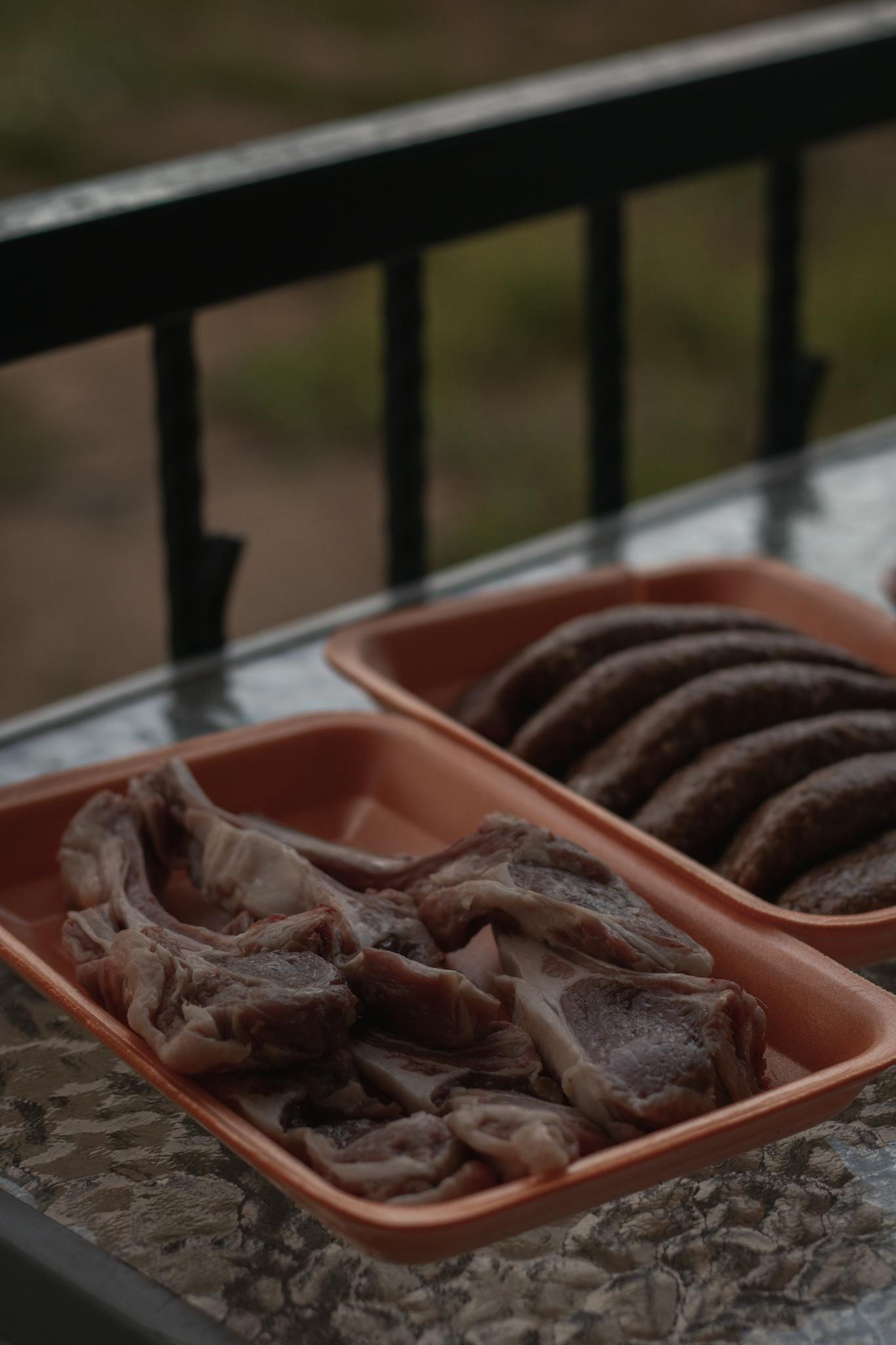 Close-up view of uncooked meat slices in plastic trays, perfect for culinary and food industry needs.